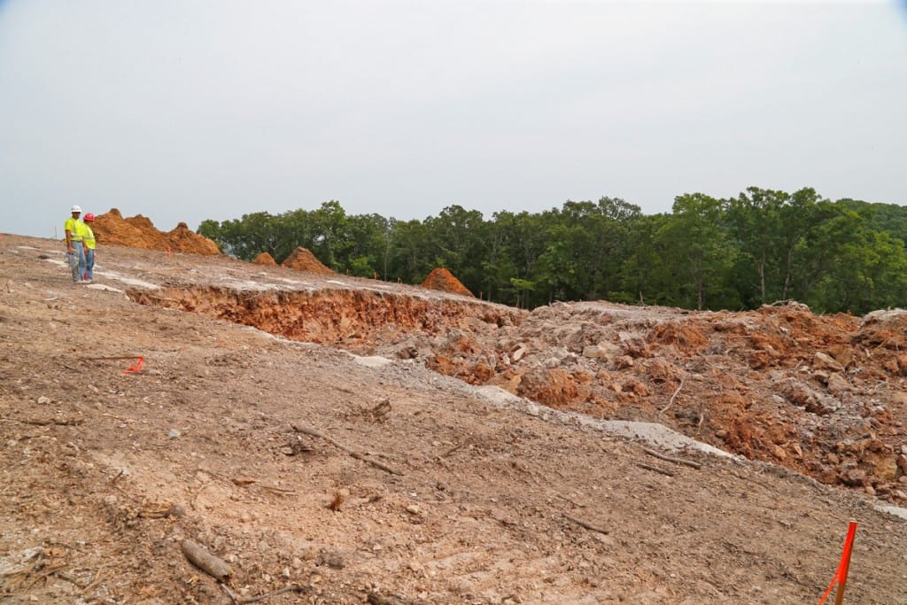 Workers from Austin Powders inspect the blast area on the hillside area after the blasting was done on Thursday August 23rd. (08/23/18)