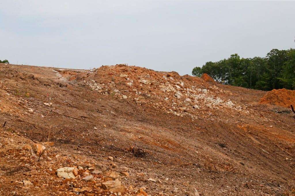 Hillside area after the blasting was done on Thursday August 23rd. The mound of rock and soil is the material moved down the hill by the blast. (08/23/18)