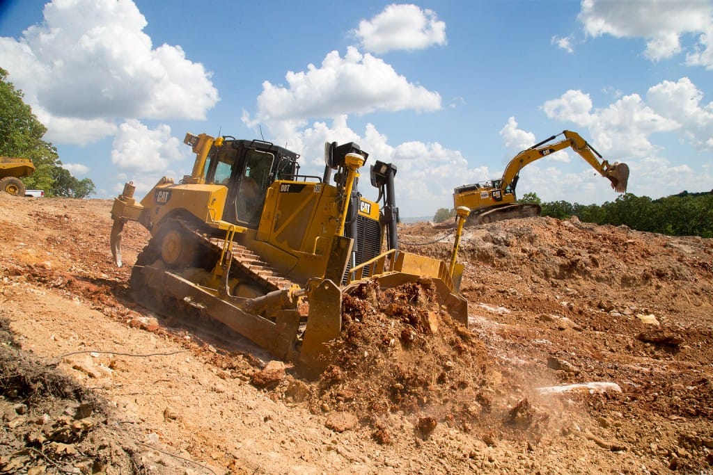 Bulldozer and excavator working in tandem to remove soil on the new range site. (09/05/18)